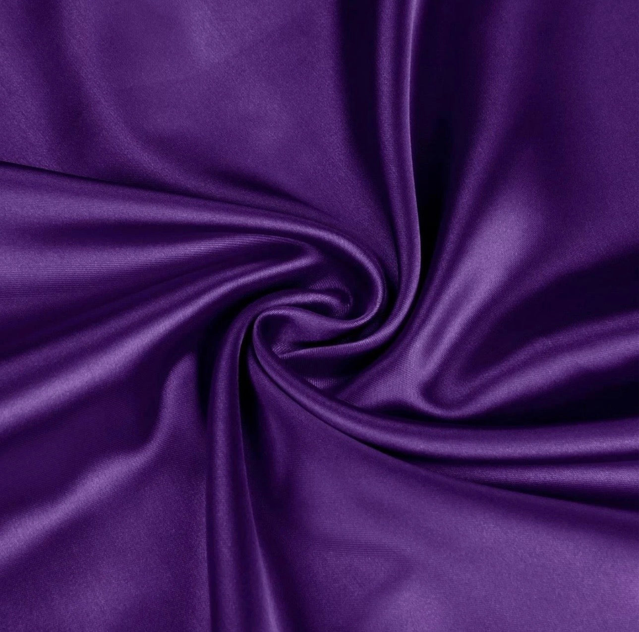 Close-up of purple satin fabric with folds