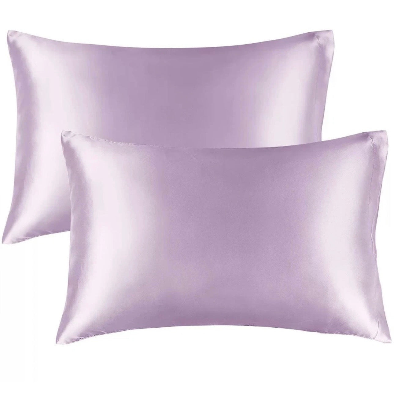 Two lavender satin pillowcases on a white background