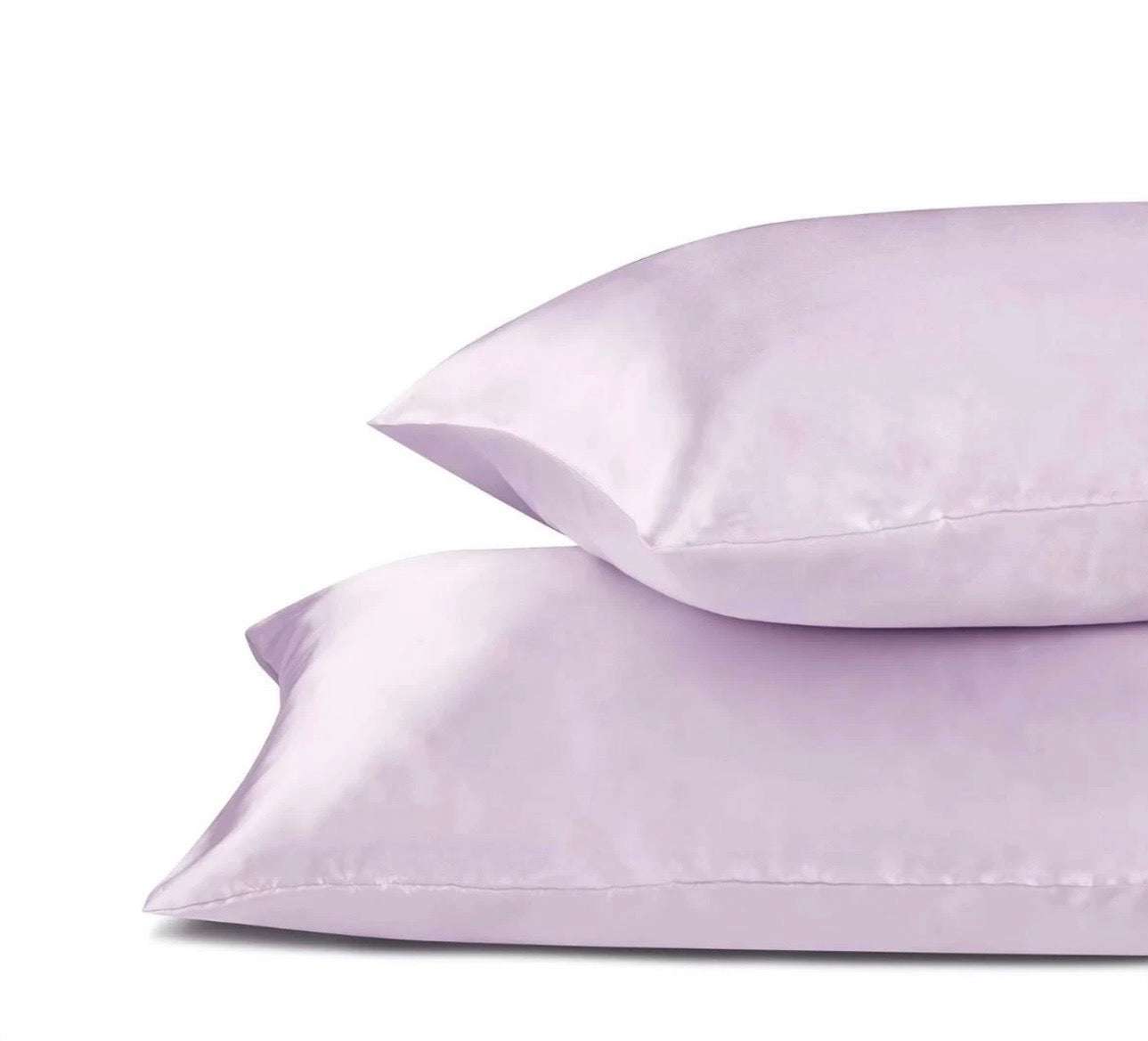 Two light purple pillows on a white background