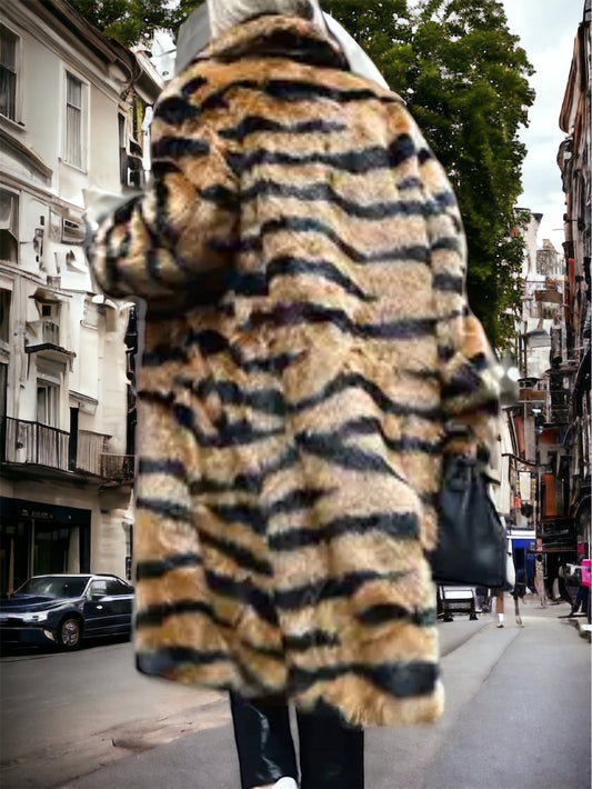 A person viewed from behind wearing a tiger print faux fur coat.